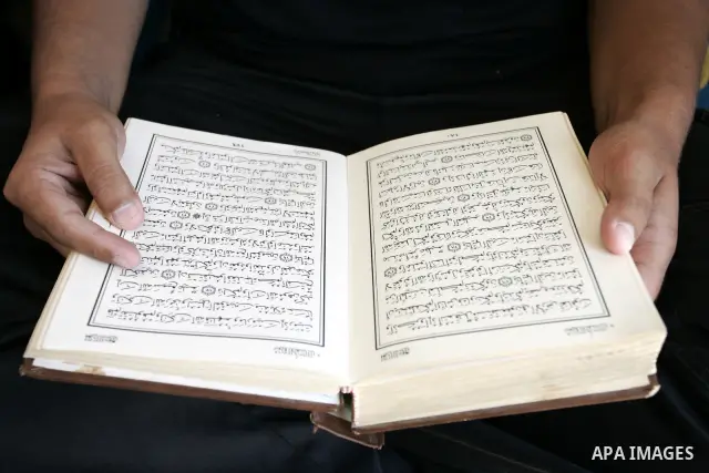 A Palestinian Hamas policeman reads the holy Koran near the tunnels between Egypt and Gaza border in Rafah, southern Gaza Strip on Aug. 8, 2011. Muslims around the world refrain from eating, drinking and sexual intercour...