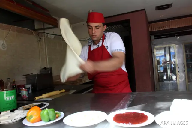 A Palestinian chef prepares Pastry or "Fatayer" with municipal ghee on a new forms at Colonel restaurant in Gaza city on Aug. 9, 2011, where prepare many forms such as pastry pizza, apple pie and pastry pillow. Muslims a...