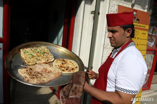 A Palestinian chef prepares Pastry or "Fatayer" with municipal ghee on a new forms at Colonel restaurant in Gaza city on Aug. 9, 2011, where prepare many forms such as pastry pizza, apple pie and pastry pillow. Muslims a...