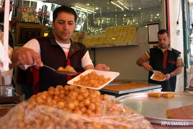 A Palestinian worker displays traditional sweets popular during the Muslim holy month of Ramadan in the West Bank city of Hebron Aug. 9, 2011. Muslims around the world abstain from eating, drinking and conducting sexual...