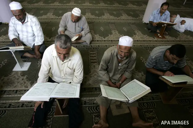 Palestinian Muslims read the holy Koran at a Mosque in Rafah, southern Gaza Strip on Aug. 9, 2011. Muslims around the world refrain from eating, drinking and sexual intercourse from dawn till dusk during Ramadan, the hol...