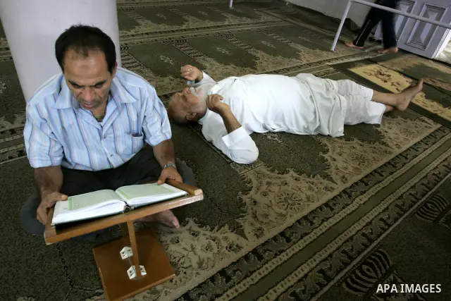 A Palestinian Muslim reads the holy Koran at a Mosque in Rafah, southern Gaza Strip on Aug. 9, 2011. Muslims around the world refrain from eating, drinking and sexual intercourse from dawn till dusk during Ramadan, the h...