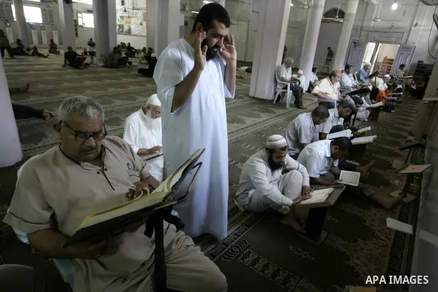 Palestinian Muslims read the holy Koran and perform prayers at a Mosque in Rafah, southern Gaza Strip on Aug. 9, 2011. Muslims around the world refrain from eating, drinking and sexual intercourse from dawn till dusk dur...