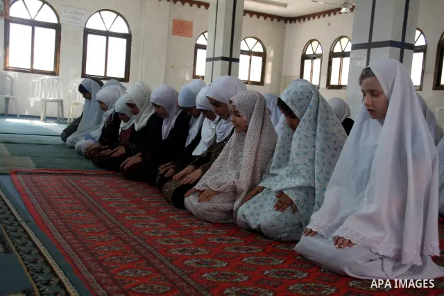 Palestinian girls read the holy Koran during the Muslim holy fasting month of Ramadan at a mosque in Balata refugee camp in the West Bank city of Nablus on Aug. 9, 2011. Muslims around the world are observing the holy fa...