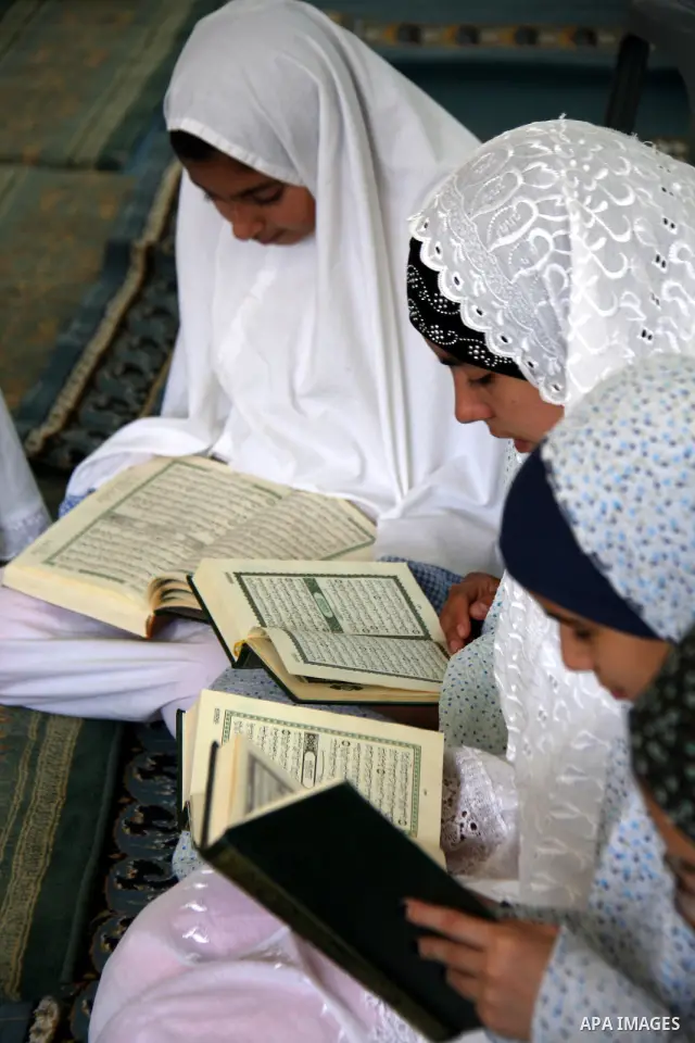 Palestinian girls read the holy Koran during the Muslim holy fasting month of Ramadan at a mosque in Balata refugee camp in the West Bank city of Nablus on Aug. 9, 2011. Muslims around the world are observing the holy fa...