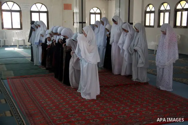 Palestinian girls read the holy Koran during the Muslim holy fasting month of Ramadan at a mosque in Balata refugee camp in the West Bank city of Nablus on Aug. 9, 2011. Muslims around the world are observing the holy fa...