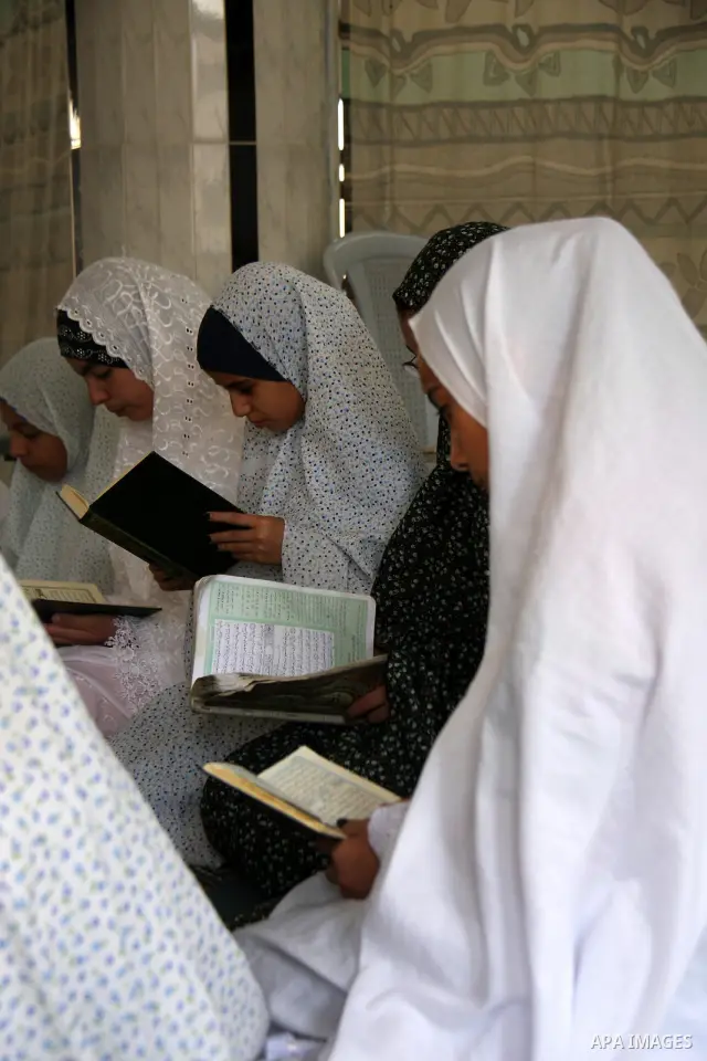 Palestinian girls read the holy Koran during the Muslim holy fasting month of Ramadan at a mosque in Balata refugee camp in the West Bank city of Nablus on Aug. 9, 2011. Muslims around the world are observing the holy fa...