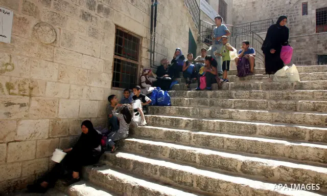 Palestinian children receive food rations on August 9,2011 distributed by the Waqf, a Jordanian-backed body that oversees Muslim holy sites in Jerusalem, on the second week of the fasting month of Ramadan in Jerusalem's...