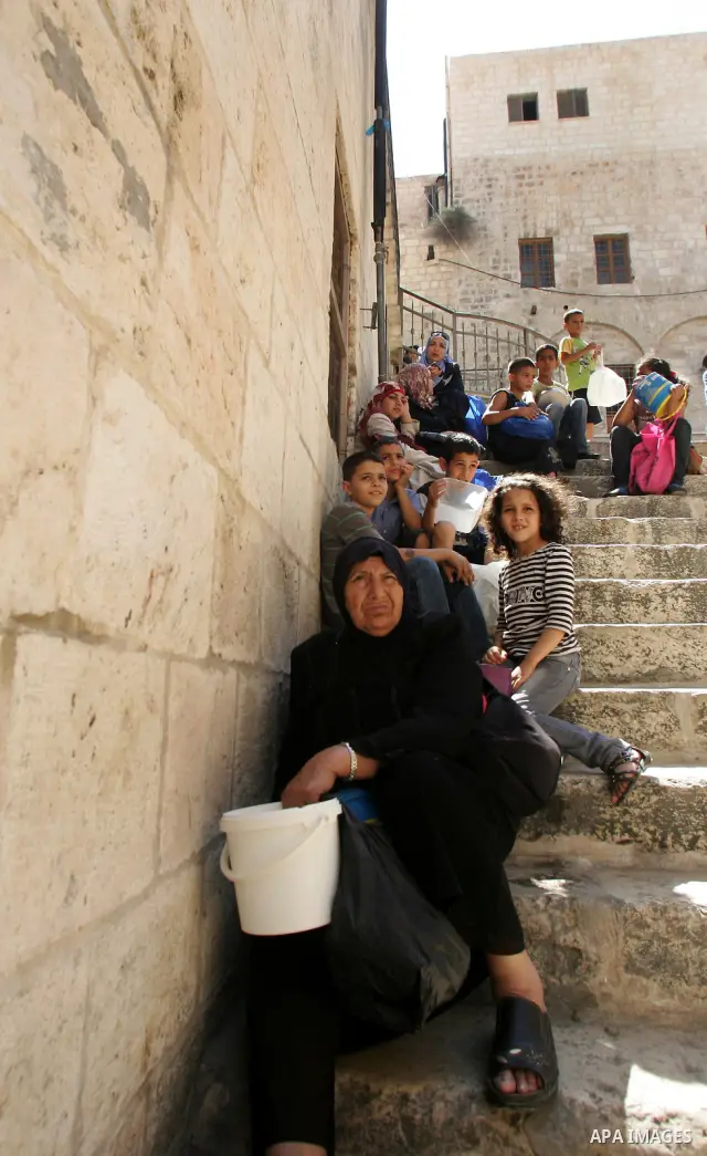 Palestinian children receive food rations on August 9,2011 distributed by the Waqf, a Jordanian-backed body that oversees Muslim holy sites in Jerusalem, on the second week of the fasting month of Ramadan in Jerusalem's...