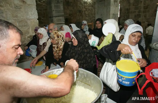 Palestinian children receive food rations on August 9,2011 distributed by the Waqf, a Jordanian-backed body that oversees Muslim holy sites in Jerusalem, on the second week of the fasting month of Ramadan in Jerusalem's...
