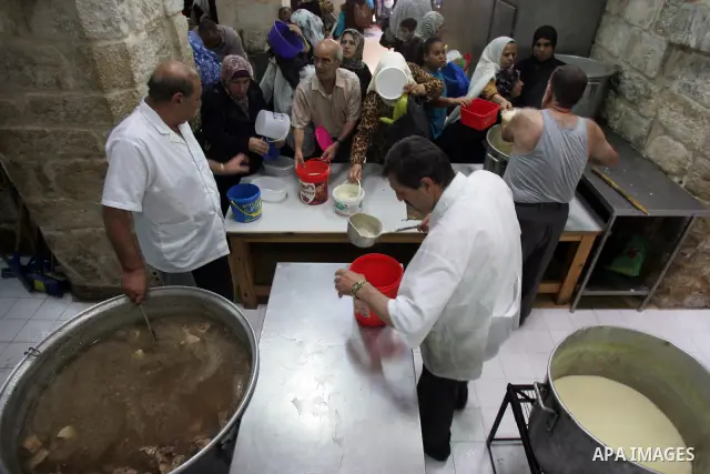 Palestinian children receive food rations on August 9,2011 distributed by the Waqf, a Jordanian-backed body that oversees Muslim holy sites in Jerusalem, on the second week of the fasting month of Ramadan in Jerusalem's...
