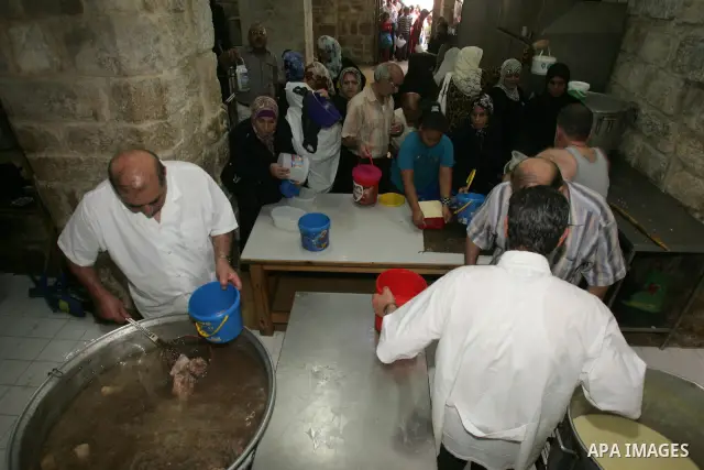 Palestinian children receive food rations on August 9,2011 distributed by the Waqf, a Jordanian-backed body that oversees Muslim holy sites in Jerusalem, on the second week of the fasting month of Ramadan in Jerusalem's...