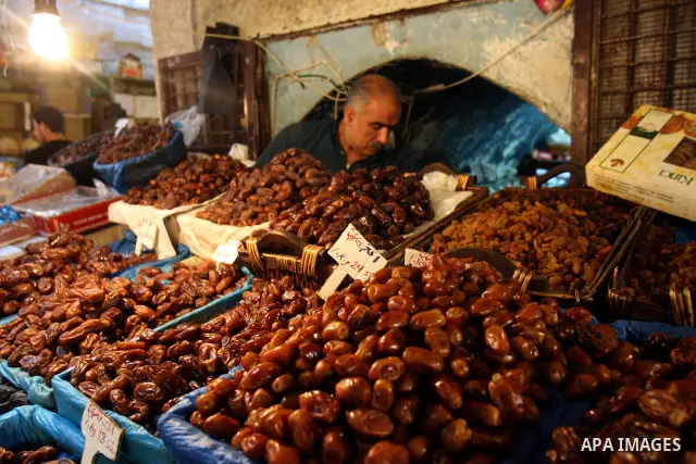 A Palestinian vendor sells dates in his shop at a market in the West Bank city of Nablus, on Aug. 10, 2011. Muslims around the world are observing the holy fasting month of Ramadan where they refrain from eating, drinkin...