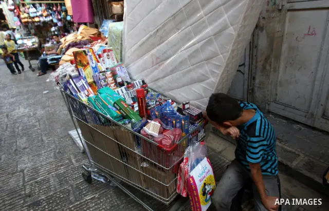 A Palestinian boy sells stuff and food stuff in a wagon at a market in the West Bank city of Nablus, on Aug. 10, 2011. Muslims around the world are observing the holy fasting month of Ramadan where they refrain from eati...