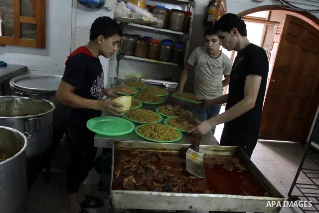 Palestinian bakers prepare rice and meat 'Qedrah" in a traditional stove at Beirut Kitchen in Gaza city on Aug. 10, 2011.during the holy fasting month of Ramadan, when observant Muslims abstain from eating, drinking and...