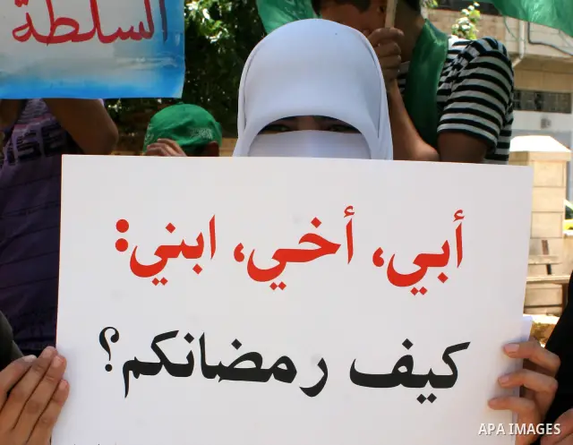 Palestinian Hamas supporters hold pictures of relatives who were arrested and imprisoned for political reasons by Palestinian Authority security forces, during a protest in the West Bank city of Hebron on Aug. 11, 2011....