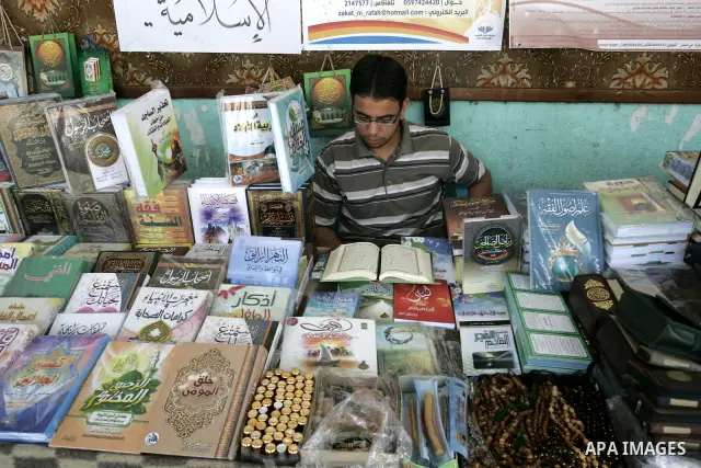 A Palestinian man reads the holy koran in his shop at a market in Rafah, southern Gaza Strip on Aug. 11, 2011. Muslims throughout the world are marking the month of Ramadan, during which they refrain from eating, drinkin...