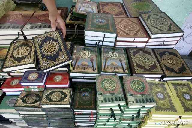 A Palestinian man sells the holy koran and Islamic books in his shop at a market in Rafah, southern Gaza Strip on Aug. 11, 2011. Muslims throughout the world are marking the month of Ramadan, during which they refrain fr...