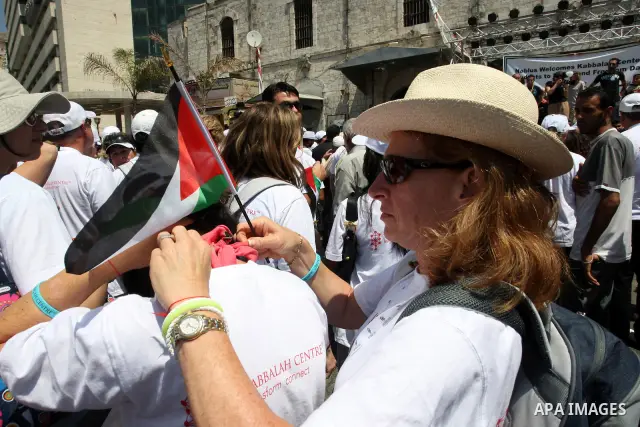 Foreign supporters with the Palestinian people take part in a demonstration in the West Bank city of Nablus, on Aug. 11, 2011. In support with the Palestinian people, where gather more than 1,200 activists from 22 foreig...