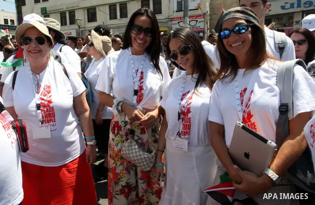 Foreign supporters with the Palestinian people take part in a demonstration in the West Bank city of Nablus, on Aug. 11, 2011. In support with the Palestinian people, where gather more than 1,200 activists from 22 foreig...