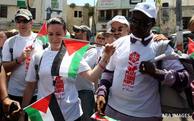 Foreign supporters with the Palestinian people take part in a demonstration in the West Bank city of Nablus, on Aug. 11, 2011. In support with the Palestinian people, where gather more than 1,200 activists from 22 foreig...