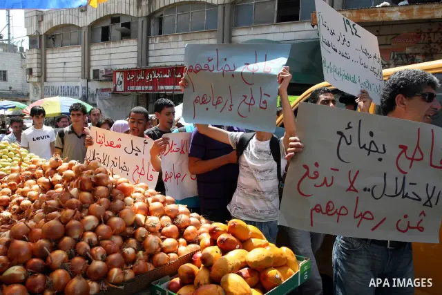 Palestinian activists hold a demonstration calling for boycotting the Israeli products from the Palestinian local markets in the West Bank city of Ramallah, on Aug. 11, 2011. Photo by Issam Rimawi