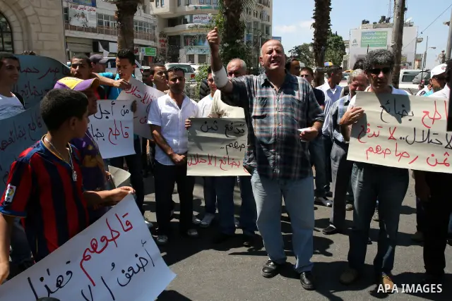 Palestinian activists hold a demonstration calling for boycotting the Israeli products from the Palestinian local markets in the West Bank city of Ramallah, on Aug. 11, 2011. Photo by Issam Rimawi