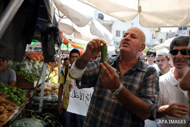 Palestinian activists hold a demonstration calling for boycotting the Israeli products from the Palestinian local markets in the West Bank city of Ramallah, on Aug. 11, 2011. Photo by Issam Rimawi