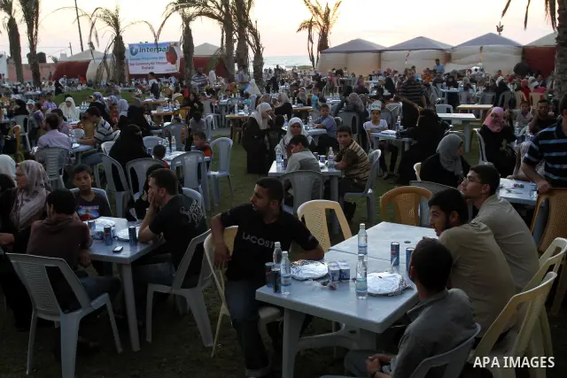 Palestinian Prime Minister in Gaza Strip, Ismail Haniya during his participation the collective meal "Iftar" with the orphans in the holiest month of Ramadan, where sponsoring by the Interpal in Gaza city on Aug. 11, 201...