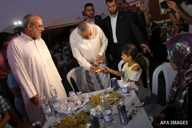 Palestinian Prime Minister in Gaza Strip, Ismail Haniya during his participation the collective meal "Iftar" with the orphans in the holiest month of Ramadan, where sponsoring by the Interpal in Gaza city on Aug. 11, 201...