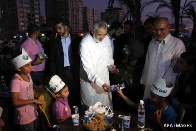 Palestinian Prime Minister in Gaza Strip, Ismail Haniya during his participation the collective meal "Iftar" with the orphans in the holiest month of Ramadan, where sponsoring by the Interpal in Gaza city on Aug. 11, 201...