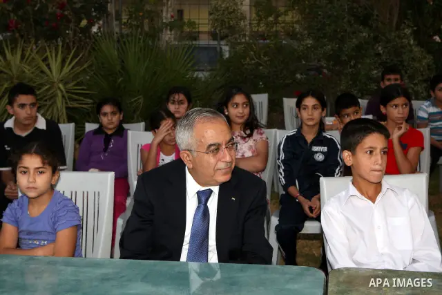 Palestinian Prime Minister, Salam Fayyad during his participation Orphans of the Orphan Care Charitable Society the meal of "Iftar" in the month of Ramadan in the West Bank city of Bethlehem on Aug. 11, 2011. Photo by Mu...