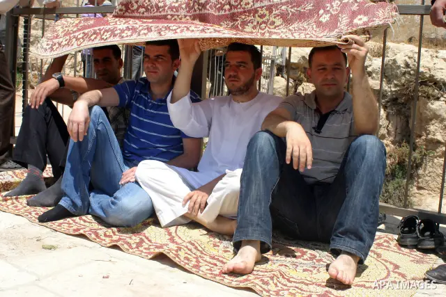 Palestinian attend the second friday prayer of Islam's holy fasting month of Ramadan outside the Ibrahimi mosque, or the Tomb of the Patriarchs, in the divided West Bank city of Hebron on August 12, 2011. Photo by Najeh...