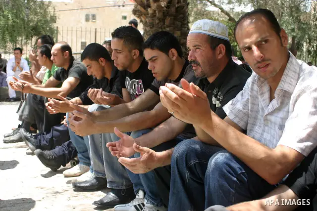Palestinian attend the second friday prayer of Islam's holy fasting month of Ramadan outside the Ibrahimi mosque, or the Tomb of the Patriarchs, in the divided West Bank city of Hebron on August 12, 2011. Photo by Najeh...
