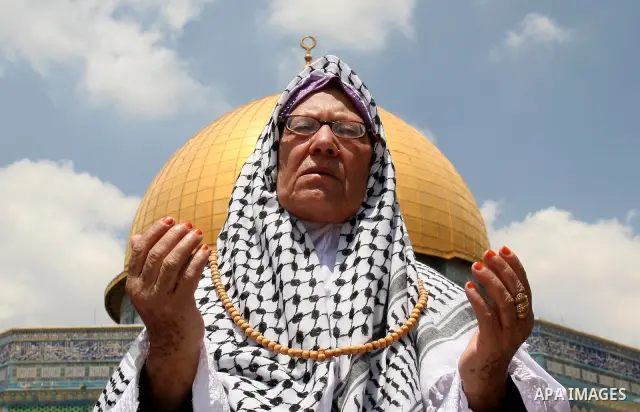 Palestinian Muslim women pray in front of the Dome of the Rock on the compound known to Muslims as al-Haram al-Sharif and to Jews as Temple Mount during the second Friday of the holy month of Ramadan in Jerusalem's Old C...
