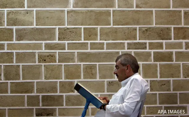 A Palestinian old man reads from the Koran in a Mosque during the holy month of Ramadan in Central of Gaza City on 12 August 2011. Muslims around the world are observing the holy fasting month of Ramadan in which they re...