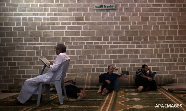 A Palestinian old man reads from the Koran in a Mosque during the holy month of Ramadan in Central of Gaza City on 12 August 2011. Muslims around the world are observing the holy fasting month of Ramadan in which they re...