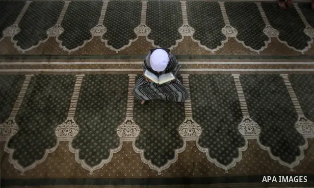 A Palestinian boy reads from the Koran in a Mosque during the holy month of Ramadan in Central of Gaza City on 12 August 2011. Muslims around the world are observing the holy fasting month of Ramadan in which they refrai...