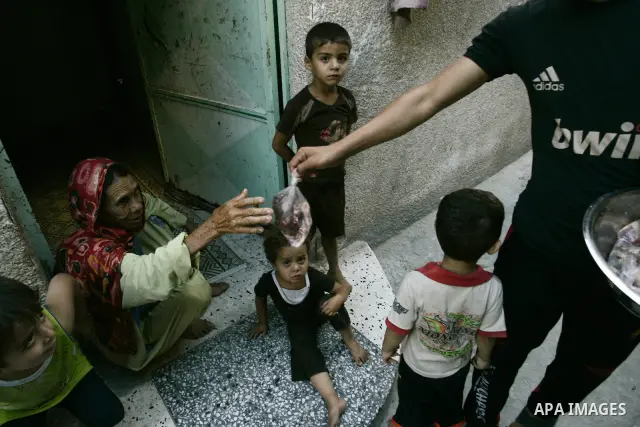 A Palestinian boy participates in the distribution of meat on the homes of the poor and needy on the thirteenth day at the occasion of the holy fasting month of Ramadan in Rafah, southern Gaza Strip on Aug. 13, 2011. whe...