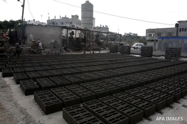 Palestinian workers use large stones for building houses in al-shejaeya camp, northern Gaza Strip on Aug. 13, 2011, as the Palestinian territory continues to lack most construction materials since the start of the siege...