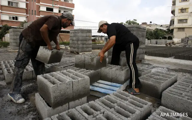 Palestinian workers use large stones for building houses in al-shejaeya camp, northern Gaza Strip on Aug. 13, 2011, as the Palestinian territory continues to lack most construction materials since the start of the siege...