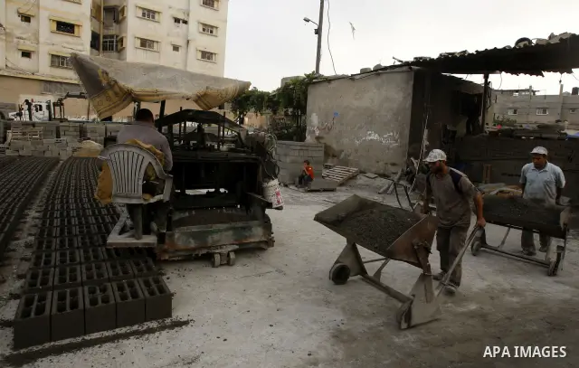 Palestinian workers use large stones for building houses in al-shejaeya camp, northern Gaza Strip on Aug. 13, 2011, as the Palestinian territory continues to lack most construction materials since the start of the siege...