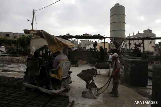 Palestinian workers use large stones for building houses in al-shejaeya camp, northern Gaza Strip on Aug. 13, 2011, as the Palestinian territory continues to lack most construction materials since the start of the siege...