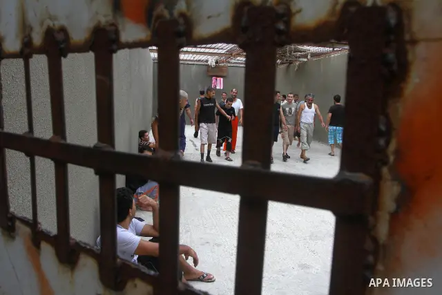 Palestinian prisoners walk and sit in a Hamas-run jail on the fourteenth day during the holy month of Ramadan in Gaza City on Aug. 14, 2011. Muslims around the world are observing the holy fasting month of Ramadan in whi...