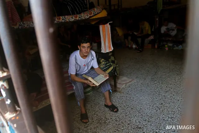 A Palestinian prisoner reads the holy Koran in a Hamas-run jail on the fourteenth day during the holy month of Ramadan in Gaza City on Aug. 14, 2011. Muslims around the world are observing the holy fasting month of Ramad...