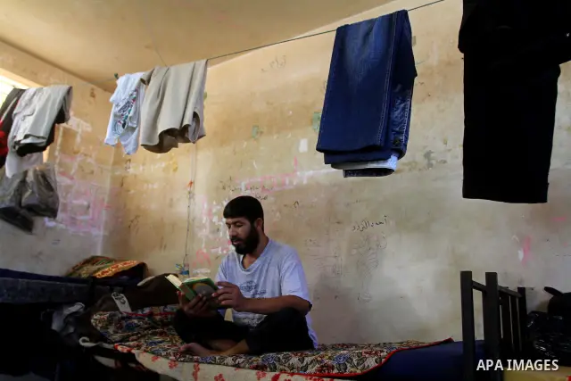A Palestinian prisoner reads the holy Koran in a Hamas-run jail on the fourteenth day during the holy month of Ramadan in Gaza City on Aug. 14, 2011. Muslims around the world are observing the holy fasting month of Ramad...