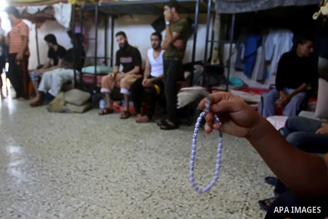 A Palestinian prisoner rest as others pray and read the Koran in a Hamas-run jail on the fourteenth day during the holy month of Ramadan Gaza City on Aug. 14, 2011. Muslims around the world are observing the holy fasting...
