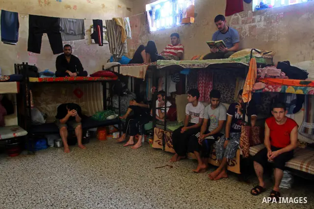 A Palestinian prisoner rest as others read the Koran in a Hamas-run jail on the fourteenth day during the holy month of Ramadan Gaza City on Aug. 14, 2011. Muslims around the world are observing the holy fasting month of...