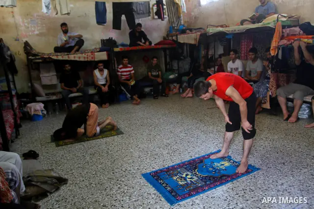 A Palestinian prisoner rest as others pray and read the Koran in a Hamas-run jail on the fourteenth day during the holy month of Ramadan Gaza City on Aug. 14, 2011. Muslims around the world are observing the holy fasting...