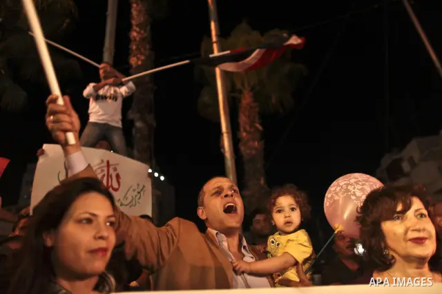 Palestinians hold Syrian flags as they join a demonstration in the West Bank city of Ramallah on Aug. 14, 2011 in support of the Syrian opposition . At least 23 people were killed 14 August when the Syrian army attacked...